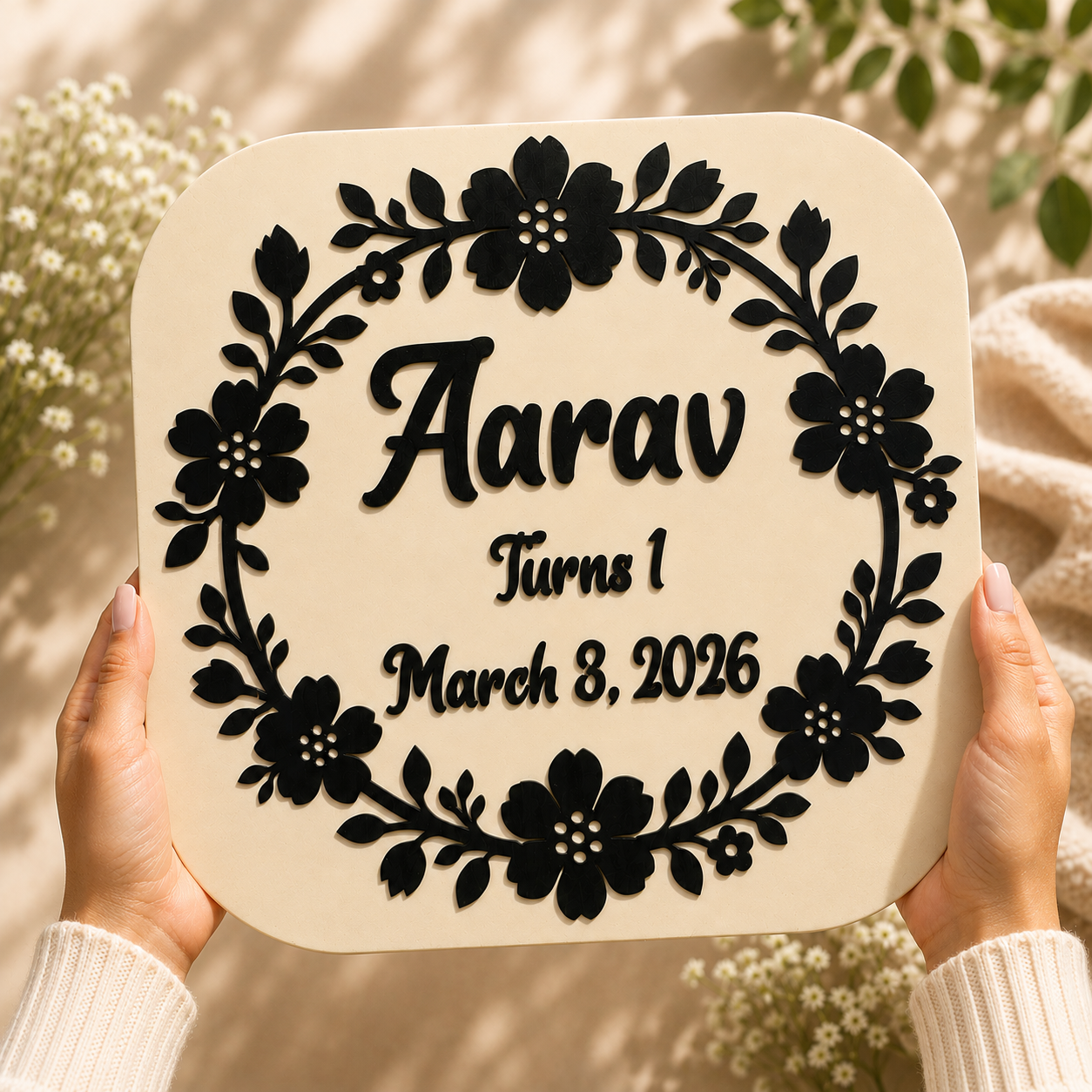 Hands holding a personalized Birthday Bloom Keepsake featuring a custom name, age, birth date, and layered floral wreath handcrafted from premium wood.